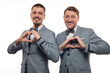 © pavel_shishkin - Two young funny men in formal clothes show heart