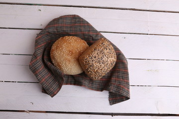 delicious bread rolls on colored background