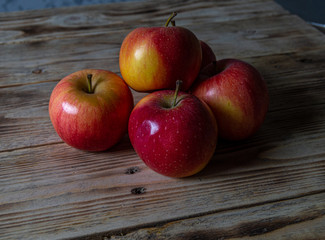 Ripe and juicy apples lie on a wooden table