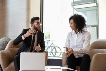 Canvas Print - Middle eastern ethnicity businessman african businesswoman discuss deal in office