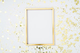 Fototapeta  - Gold frame with gold stars on white background. Flat lay, top view, copy space