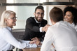 © fizkes - Arabian executive manager shake hands client accomplish successful negotiations