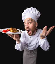 Funny Chef Showing Roasted Chicken On Plate, Black Background, High-Angle