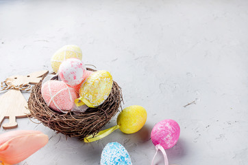 Wall Mural - Easter background with colored Decorative eggs in the nest and tulips