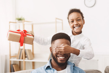 Wall Mural - Cute afro girl closing father's eyes and making surprise