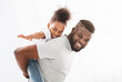 © Prostock-studio - Portrait of happy black family having fun over white backgroud