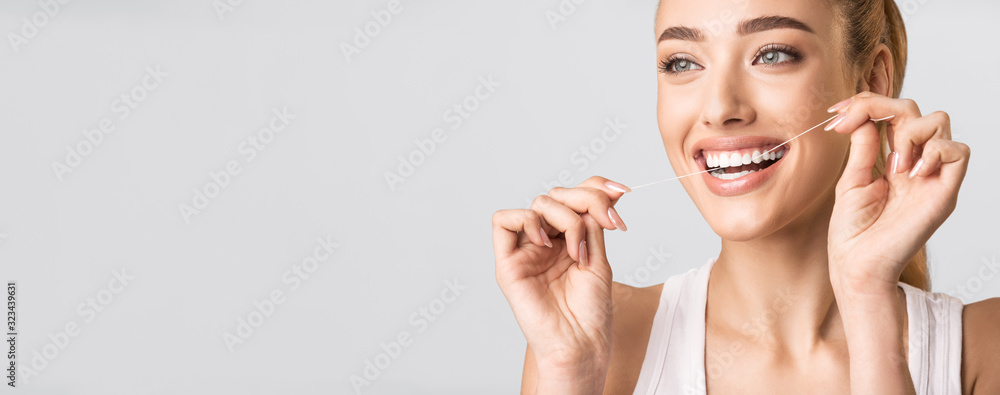 Smiling Woman Flossing Perfect Teeth Standing Over Gray Background, Panorama - obrazy, fototapety, plakaty 