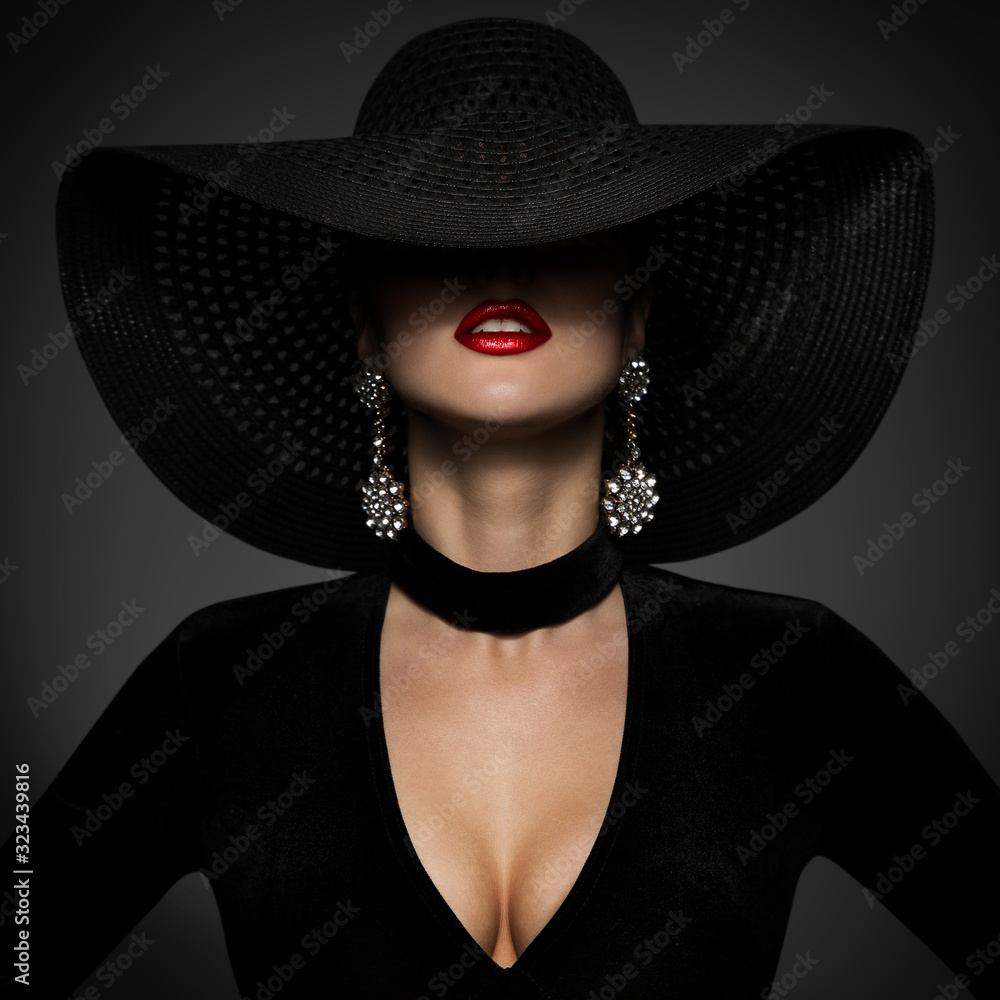 Fashion Model in Sexy Black Dress, Elegant Woman Beauty in Wide Broad Brim Hat covered face - obrazy, fototapety, plakaty 
