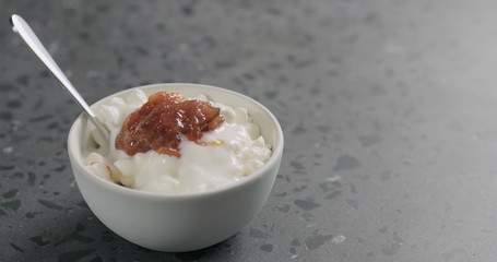 Wall Mural - cottage cheese with fig marmalade and yogurt in white bowl on concrete surface