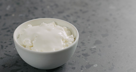 Sticker - cottage cheese with yogurt in white bowl on concrete surface