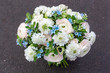 Beautiful white and blue bouquet of flowers from buttercups, roses