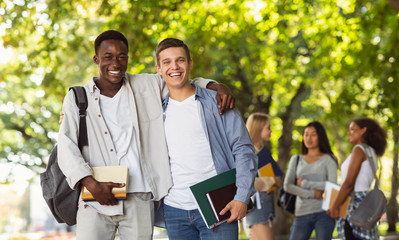 Two international students posing at camera at park