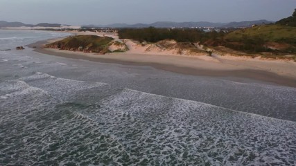 Wall Mural - Low flight on isolated beach in the morning at golden hour.