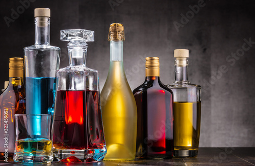 Fotomural Carafe and bottles of assorted alcoholic beverages.