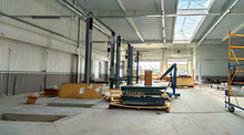  The Interior Of A Modern Automotive Dealership Maintenance Garage, With Hydraulic Lifts, Exhaust Ventilation System, Tool Storage And Energy Efficient Lighting.