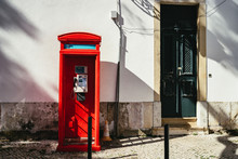 Old Bright Red Public Telephone Booth In A Street