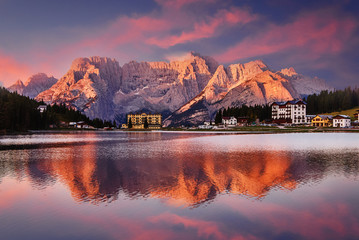 Wall Mural - Amazing nature view of Misurina Lake during sunset. Fantastic View on majestic mountains peak under warm ewening sunlight. Dramatic picturesque scene in Dolomites alps. Misurina, South Tyrol, Italy.