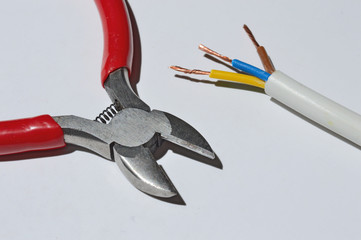 Wall Mural - wire cutters, wire, electrical tape on a white background. top view.