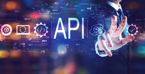 API - application programming interface concept with businessman on night city background