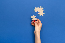 Hand Holding Piece Of Jigsaw Puzzle