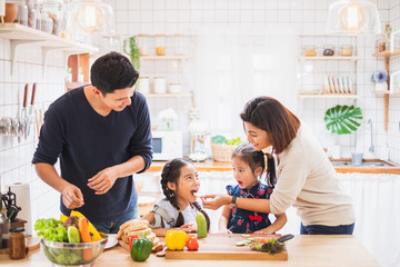 Wall Mural - Asian family enjoy playing and cooking food in kitchen at home