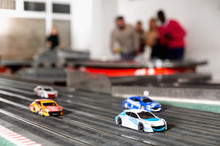Slot Car Racing Track. Emotional Players Drive Toy Cars