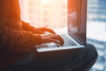 Female Hands Typing On Laptop, Young Woman Sitting Next To Window And Working Online Or Watching Video At The Morning Sunlight