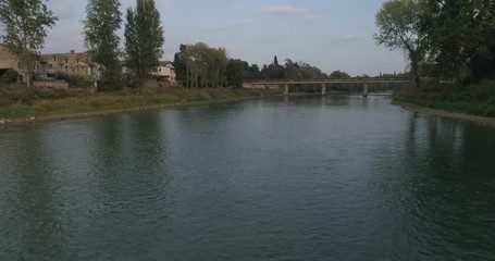 Wall Mural - Adige river seen from above with drone, Pescantina village