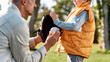 © Svitlana - New skills. Father teaching son baseball in the park on a sunny day