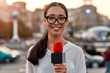 © Svitlana - Leading the way. TV reporter presenting the news outdoors. Journalism industry, live streaming concept.