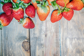 Wall Mural - strawberry berries close up on a wood background