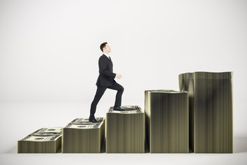 Wall Mural - Businessman rises in stacks of money in form graph