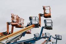 Colorful Cherry Picker Crane Buckets In The Air