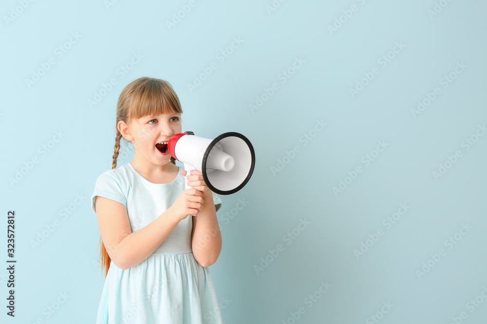 Cute little girl with megaphone on color background