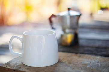 Coffee cups on wood, mocha pots, morning coffee with beautiful sunlight