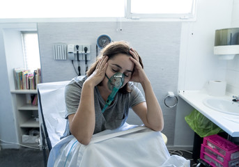 Wall Mural - Sick woman with oxygen mask in emergency room at hospital