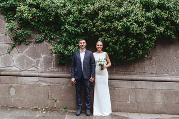 Wall Mural - Happy bride and groom near old castle in wedding day