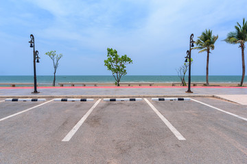 Wall Mural - Empty parking lot against sea and beautiful blue sky.