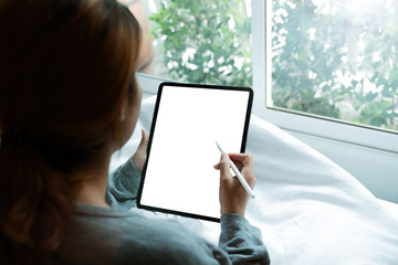 Poster - women using digital tablet on bed in morning