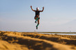 © TheVisualsYouNeed - young athletic and attractive crazy happy woman jumping high on the air at beautiful beach enjoying freedom and nature during fitness workout outdoors in healthy lifestyle