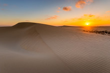 Sand Dunes In The National Park Of Dunas De Corralejo During A Beautiful Sunrise- Canary Islands - Fuerteventura.