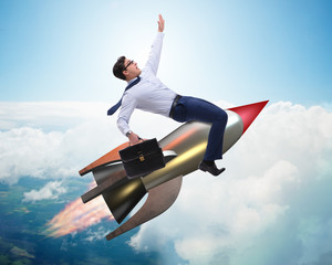 Wall Mural - Businessman flying on rocket in business concept