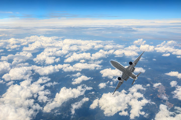 Airplane flying at high altitude and beautiful high-altitude clouds in spring