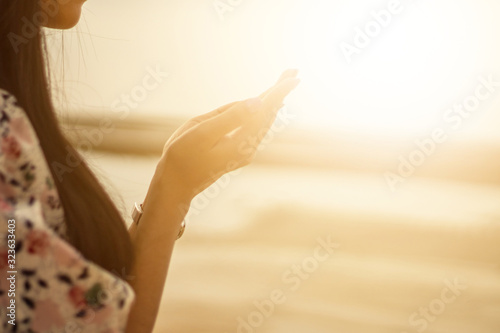 A woman praying hand for blessings When the sun goes down Hope for a happy life