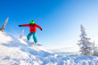 © Parilov - Young man snowboarder jump down slope mountains forest. Winter sport sun day, blue sky, fast speed dust snow