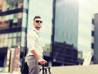 Wall Mural - business, lifestyle, transport and people concept - young man with bicycle on city street