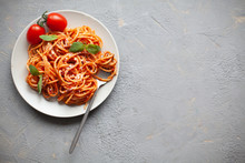 Tasty Appetizing Classic Italian Spaghetti Pasta With Tomato Sauce, Cheese Parmesan And Basil On Plate On Grey Backgroound