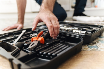 Sticker - Plumber work in uniform indoors with case with equipment.