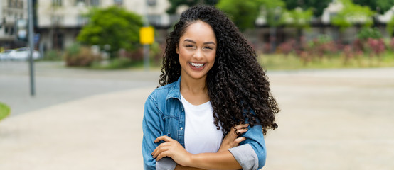 Brazilian girl with curly hair and braces and copy space