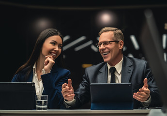 Wall Mural - The smiling man and woman sitting at the table on business conference